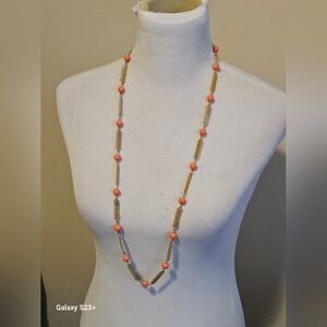 Beautiful long vintage necklace with peach color bead and gold tone necklace.